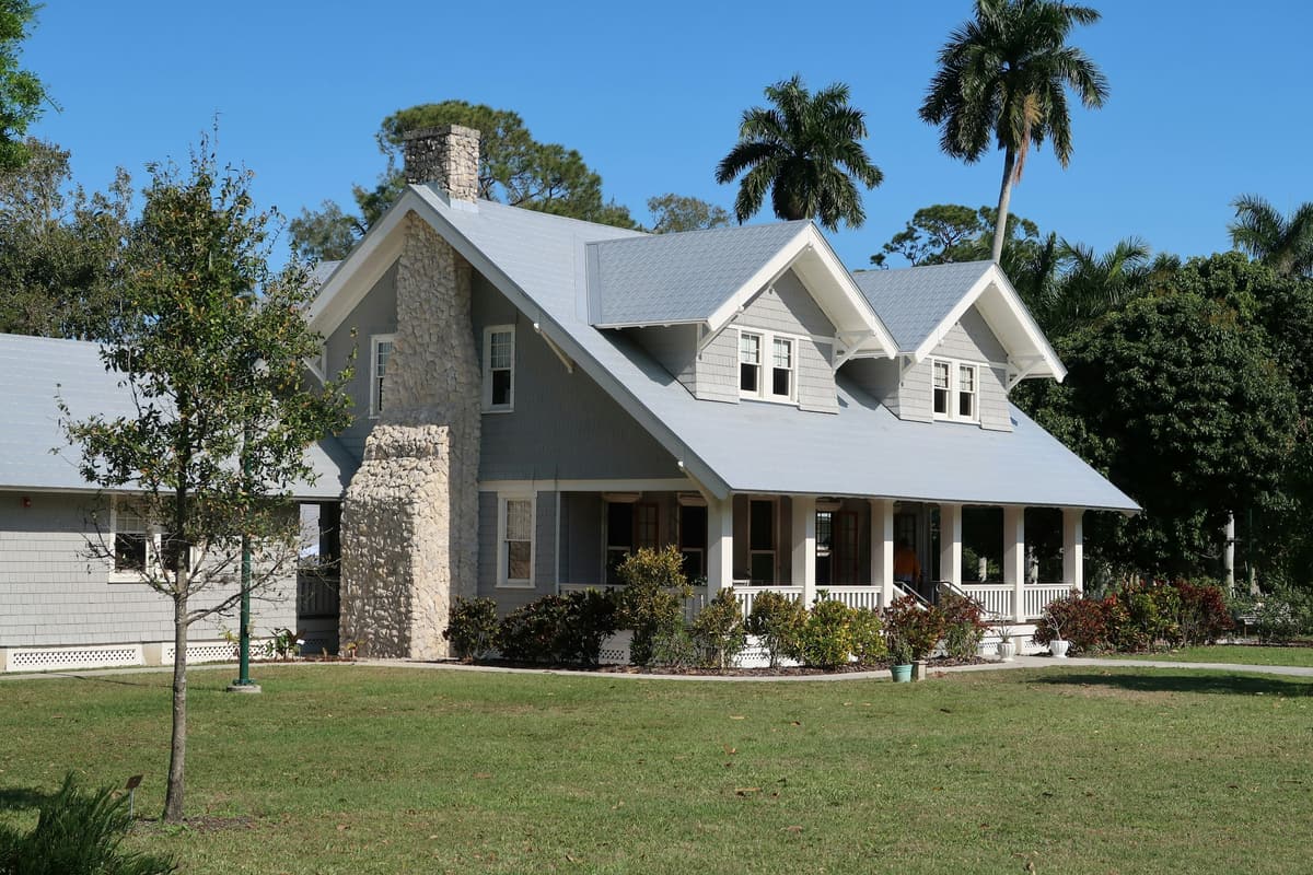 A home at golden hour, framed by palms